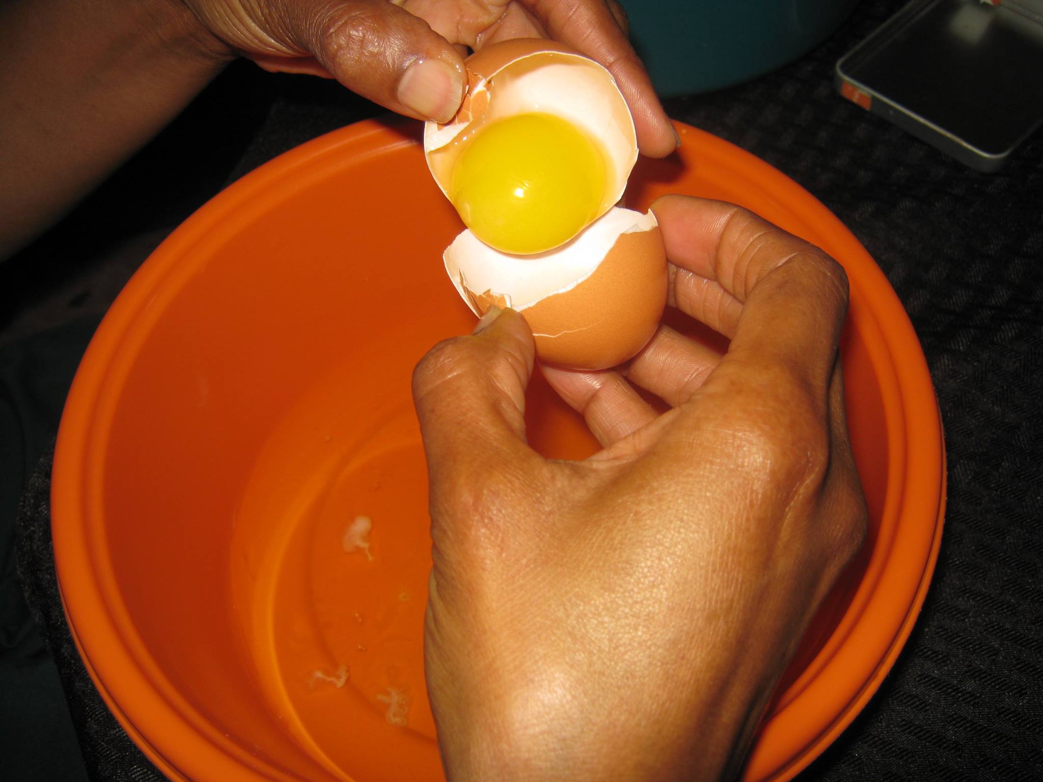 Egg yolk being separated from white