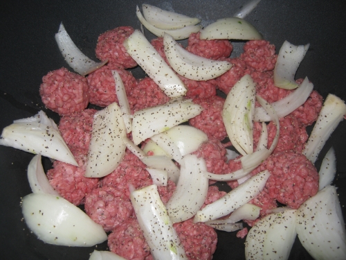 Meatballs and onions in a wok