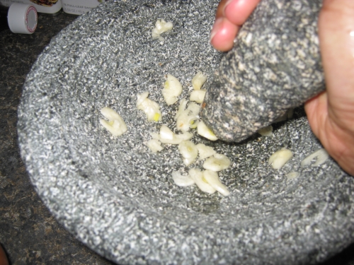 Pounding garlic into a pulp